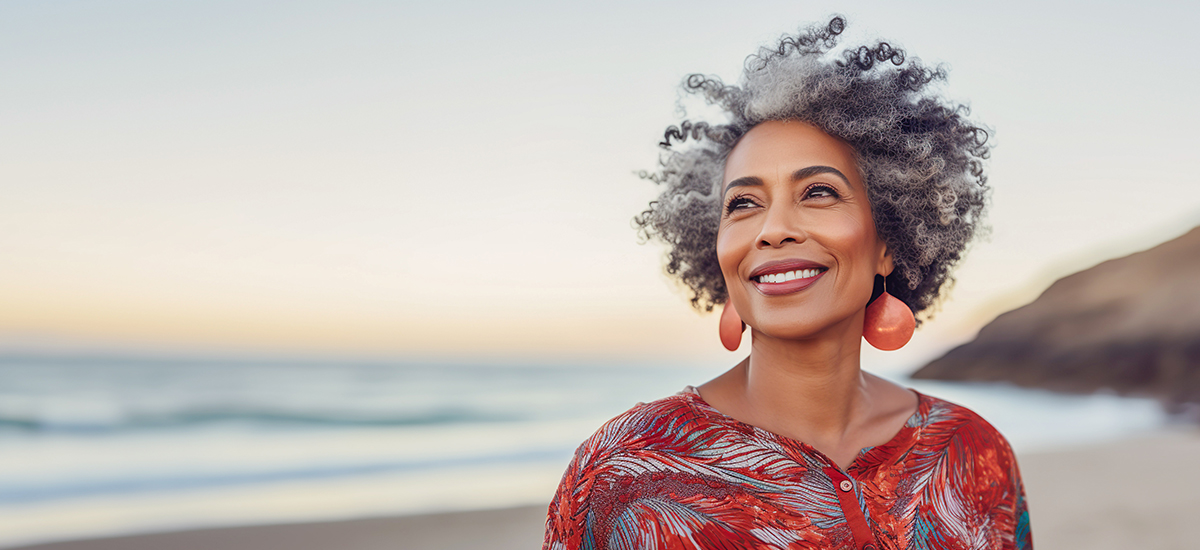 Mature woman smiling on beach from good hearing